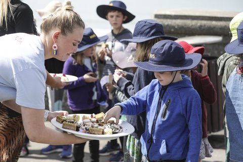 Children from Houghton Valley School get to enjoy cakes left over from the royal pair's visit at Maranui cafe.