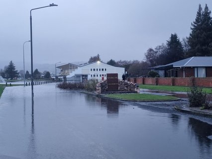 The road into the Memorial Park in Mosgiel has surface flooding and part of the sport ground looks like a lake.